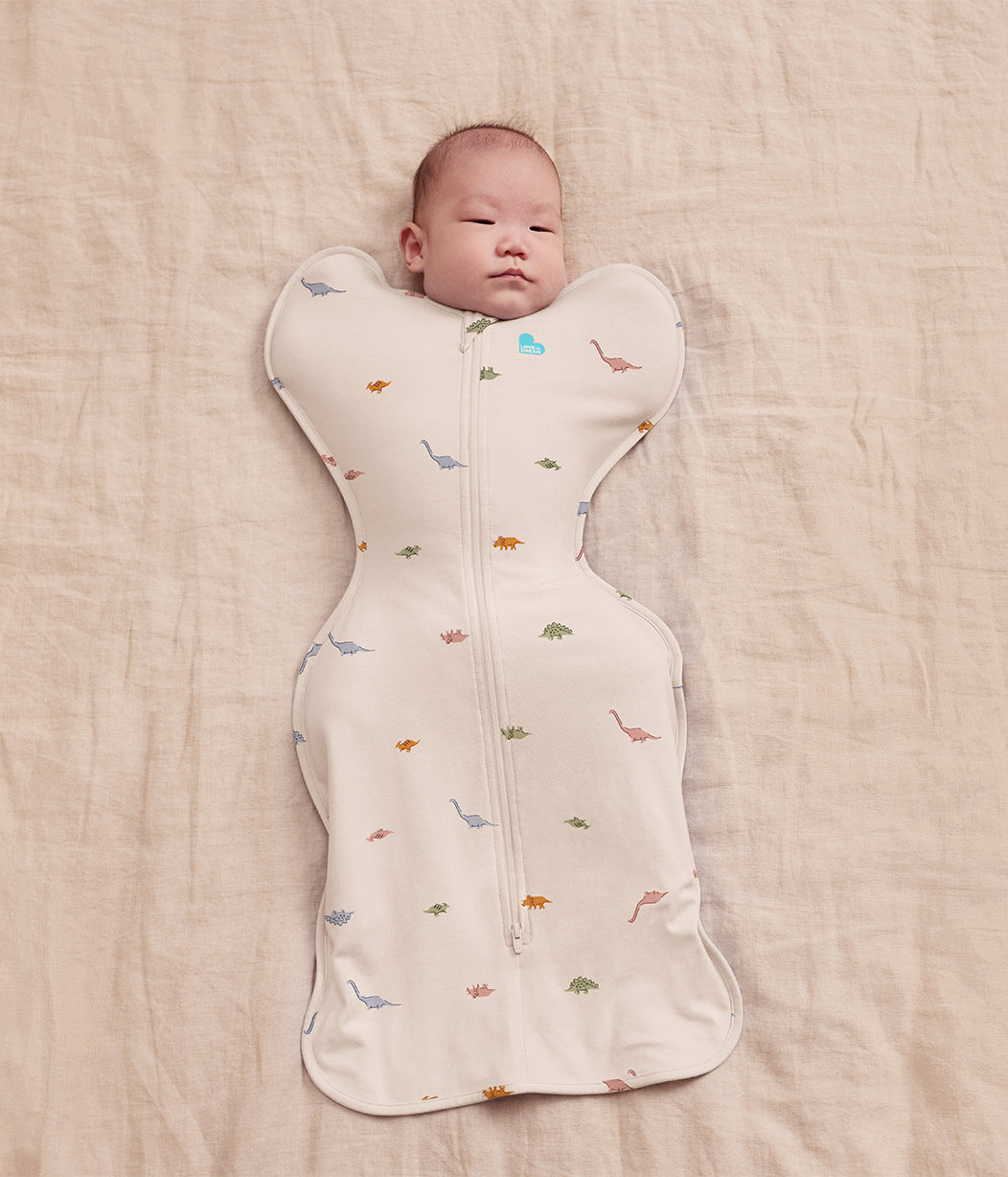 Sacco nanna Swaddle Up™ per neonati 1.0 TOG in cotone color crema Dino Snore