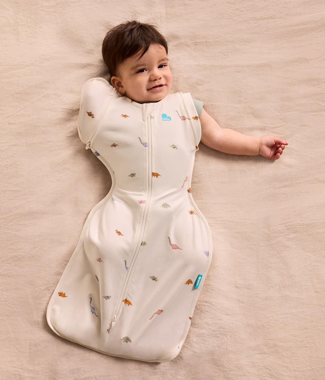 Fasciatoio transizione 2 in 1 Swaddle Up™ 1.0 TOG cotone crema Dino-russamento